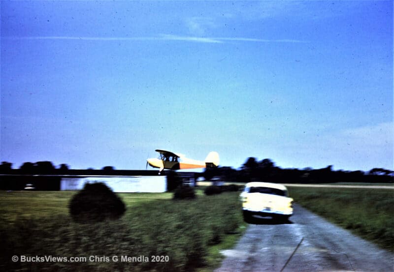 Vintage photo of a plan landing on a grass strip in Bucks County. 